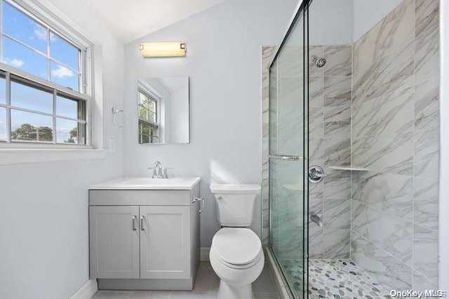 bathroom with a wealth of natural light, a shower with shower door, lofted ceiling, and toilet