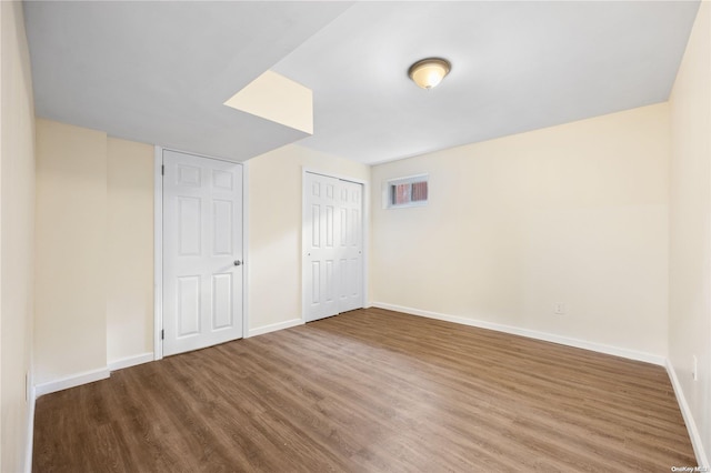 unfurnished bedroom with hardwood / wood-style flooring