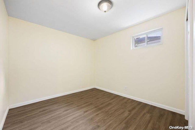 unfurnished room featuring dark hardwood / wood-style flooring