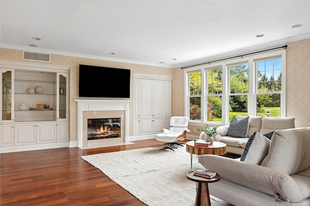 living room with dark hardwood / wood-style flooring and crown molding