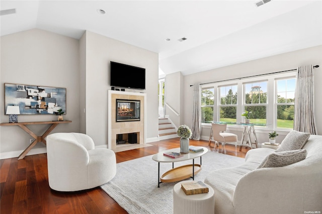 living room with a fireplace, lofted ceiling, and hardwood / wood-style flooring