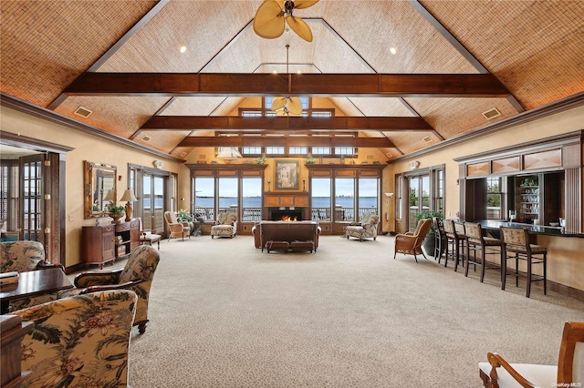 living room featuring carpet flooring, ceiling fan, beamed ceiling, and high vaulted ceiling