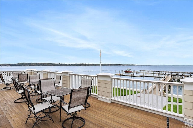 wooden terrace featuring a water view