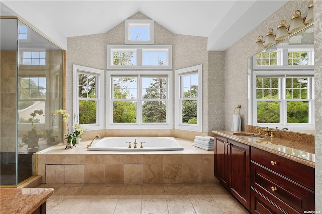 bathroom with plus walk in shower, vanity, a healthy amount of sunlight, and lofted ceiling