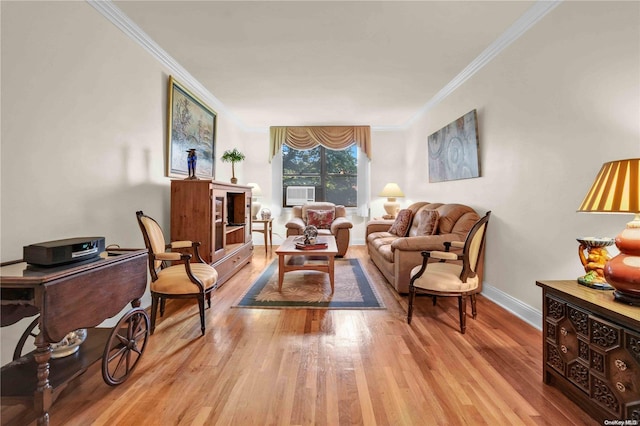 living room featuring light wood-type flooring and ornamental molding