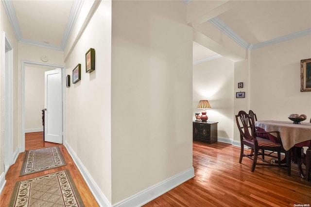 hallway featuring hardwood / wood-style floors and crown molding