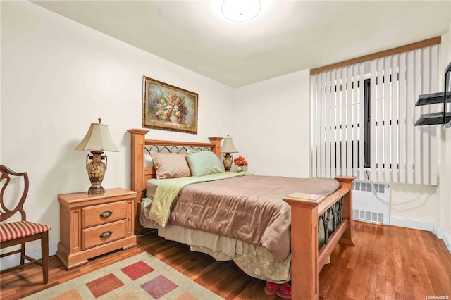 bedroom featuring wood-type flooring and radiator