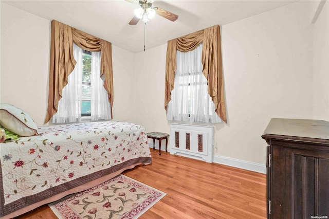 bedroom with light hardwood / wood-style floors and ceiling fan