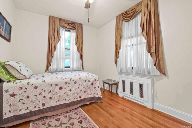 bedroom with hardwood / wood-style flooring and ceiling fan