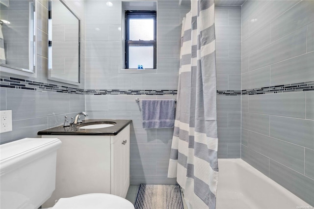 full bathroom featuring tasteful backsplash, vanity, shower / tub combo with curtain, tile walls, and toilet