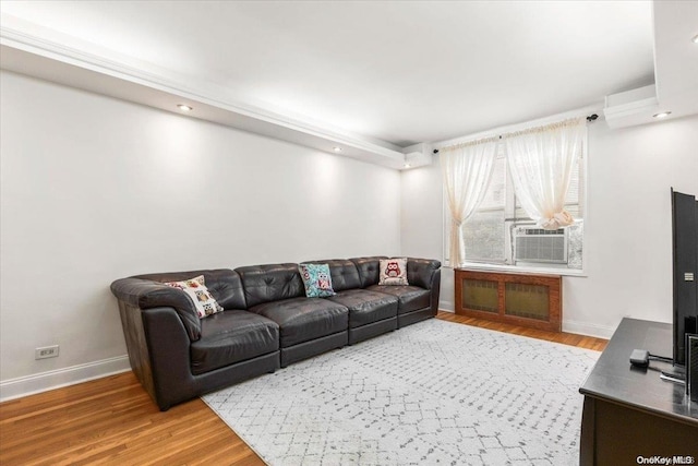 living room featuring a wall mounted AC, hardwood / wood-style floors, and cooling unit