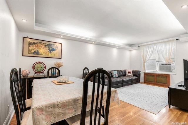 dining room with light hardwood / wood-style floors and cooling unit