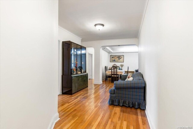 64-11 99th St Unit 304, Rego Park, NY 11374 - hallway with arched walkways, light wood-style flooring, and ornamental molding
