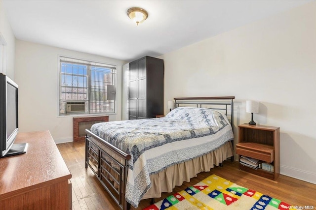 bedroom featuring cooling unit and dark wood-type flooring