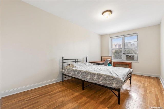 bedroom with hardwood / wood-style flooring and cooling unit