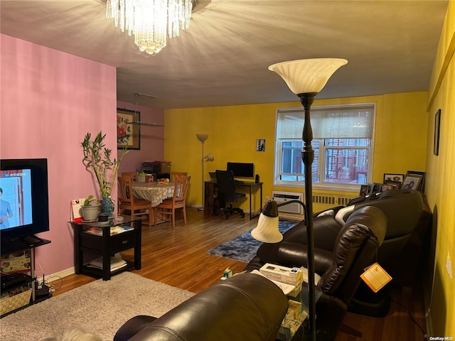 living room with a chandelier and wood-type flooring