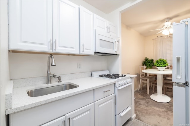 kitchen featuring white cabinetry, sink, light stone countertops, light colored carpet, and white appliances