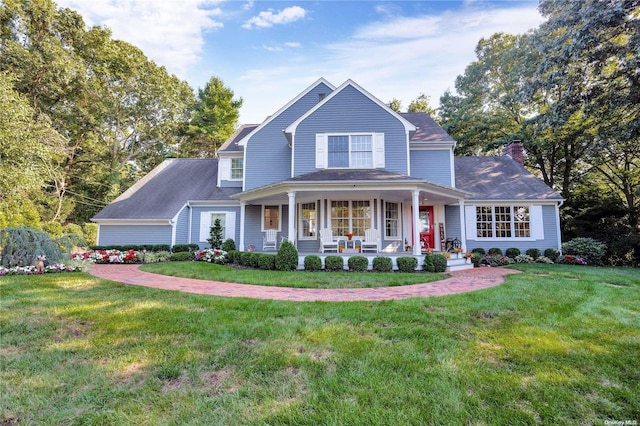 view of front of house with covered porch and a front yard