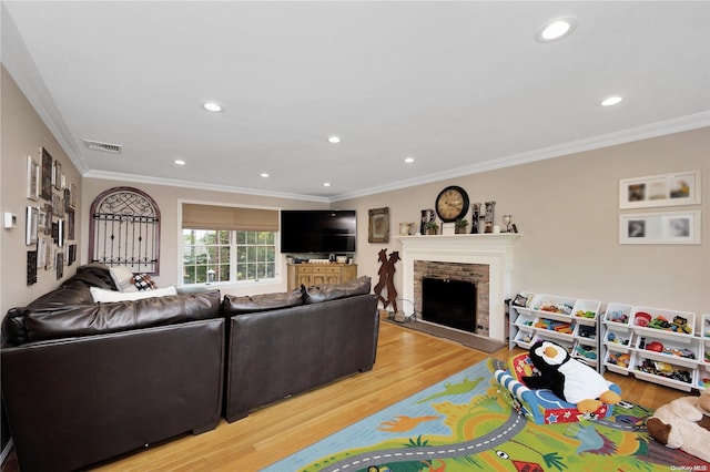 living room with hardwood / wood-style flooring, crown molding, and a brick fireplace