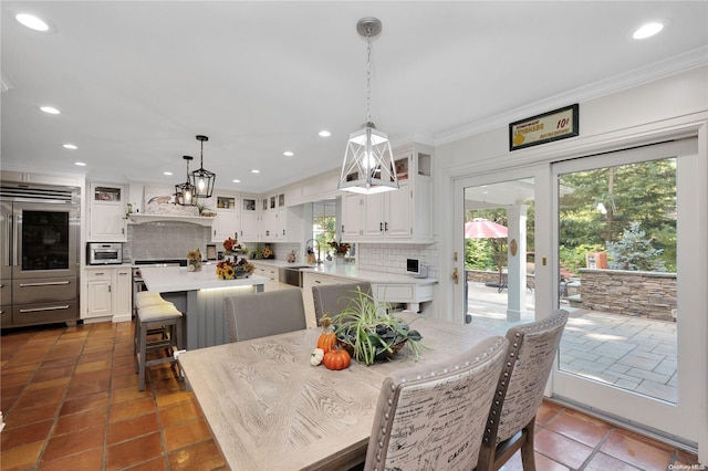 tiled dining area featuring ornamental molding and sink