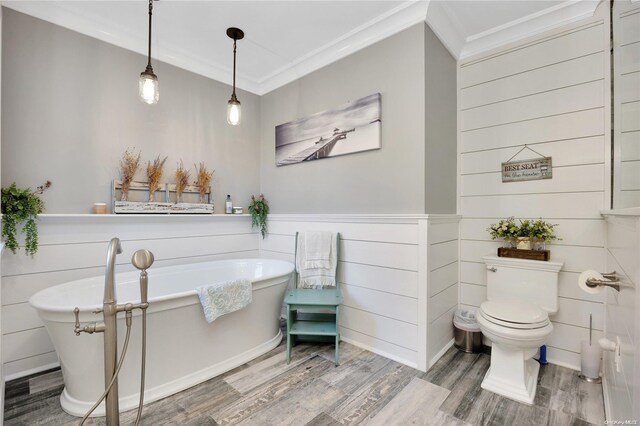 bathroom featuring a tub, wood-type flooring, toilet, tile walls, and ornamental molding