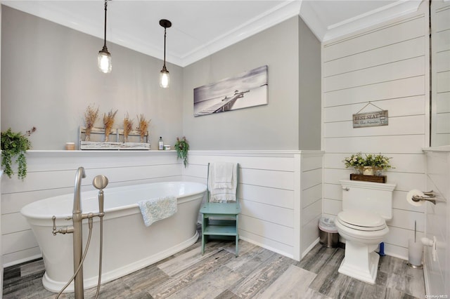 11A Sunken Meadow Rd Unit A, Northport, NY 11768 - bathroom with ornamental molding, wood finished floors, a freestanding bath, and toilet