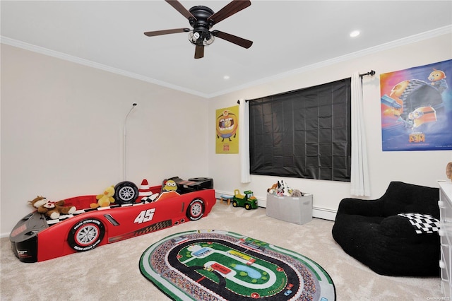 recreation room with carpet, a baseboard radiator, ceiling fan, and crown molding