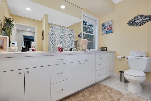 bathroom featuring tile patterned floors, vanity, and toilet