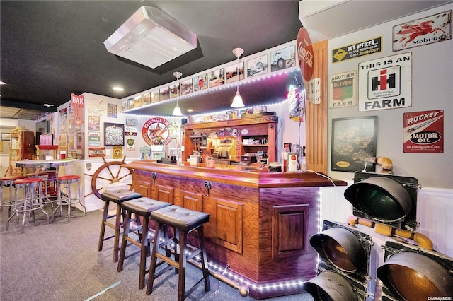 bar with carpet and hanging light fixtures