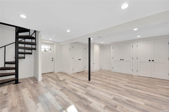 basement with light hardwood / wood-style flooring