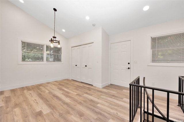 entrance foyer with light hardwood / wood-style floors and lofted ceiling