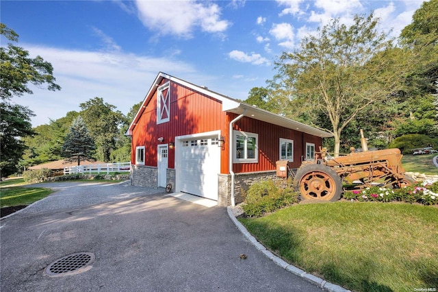 11A Sunken Meadow Rd Unit A, Northport, NY 11768 - view of front of property featuring stone siding, asphalt driveway, and a detached garage