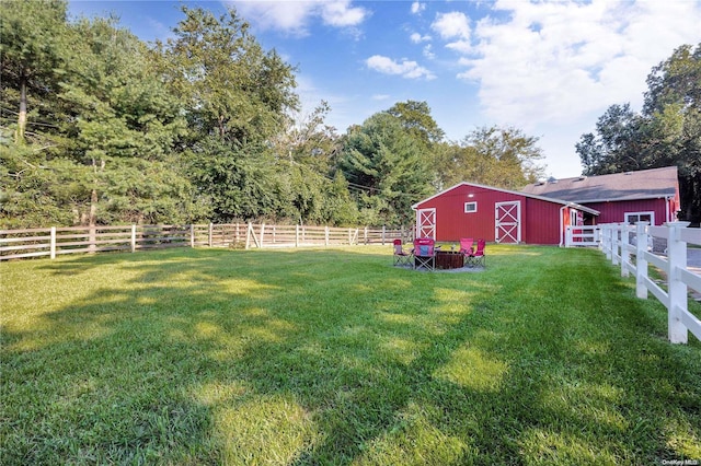 view of yard with an outbuilding and a rural view