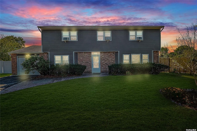 view of front of house with a yard and a garage