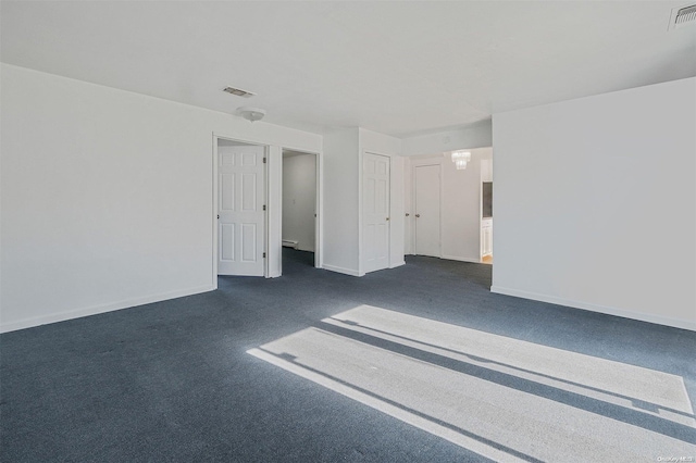 empty room featuring dark colored carpet