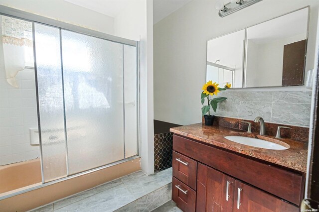 bathroom featuring decorative backsplash, tile patterned flooring, and vanity