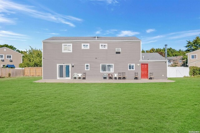 rear view of property with a lawn and a patio area