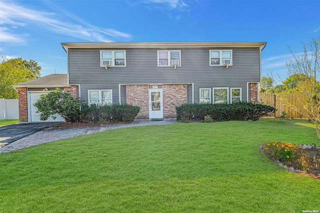 view of front of property with a front yard and a garage