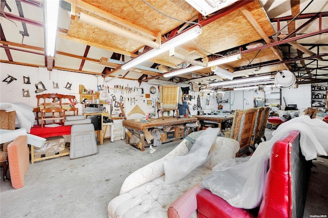 miscellaneous room featuring concrete flooring and a workshop area