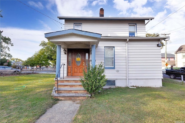 bungalow-style home with a front yard