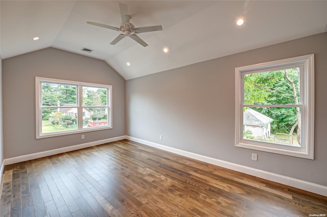 spare room featuring ceiling fan, plenty of natural light, hardwood / wood-style floors, and vaulted ceiling