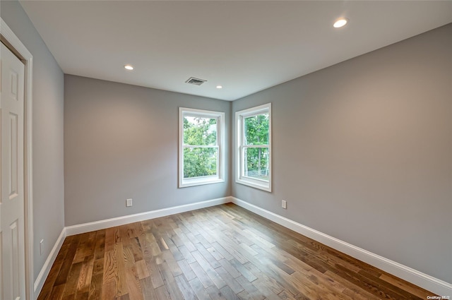 unfurnished room featuring hardwood / wood-style flooring