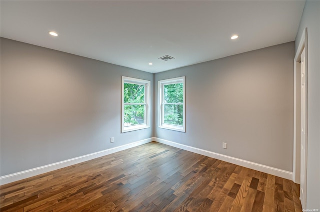 spare room featuring dark hardwood / wood-style flooring