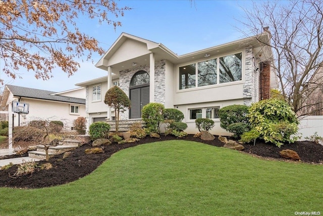 view of front of property with a front lawn and a garage