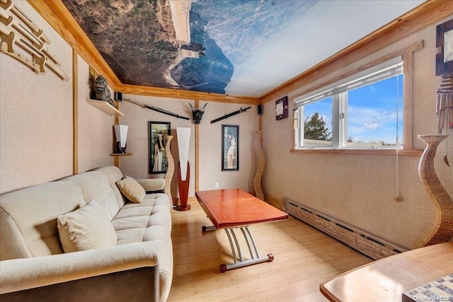 living room featuring wood-type flooring, ornamental molding, and a baseboard heating unit