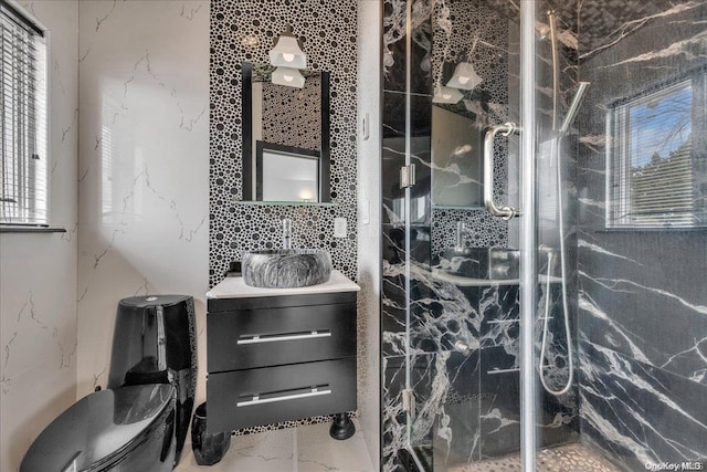 bathroom featuring tiled shower, toilet, tile walls, and sink