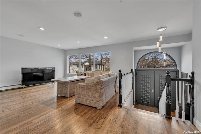 living room with light hardwood / wood-style floors and baseboard heating