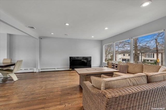 living room featuring wood-type flooring and a baseboard radiator