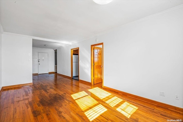 spare room with hardwood / wood-style flooring and ornamental molding