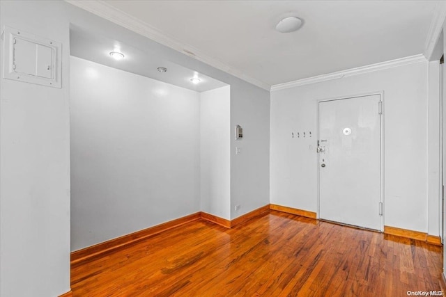 unfurnished room with wood-type flooring and crown molding